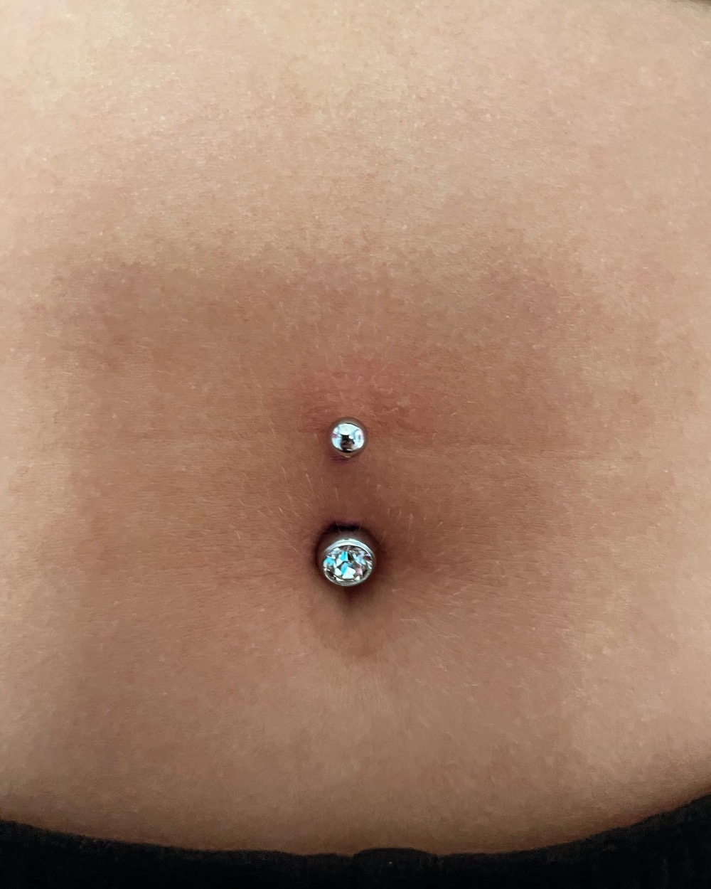 Navel piercing with a jewelled bar