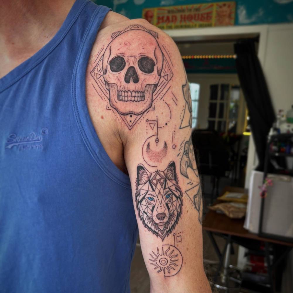 Skull and wolf on a shoulder
