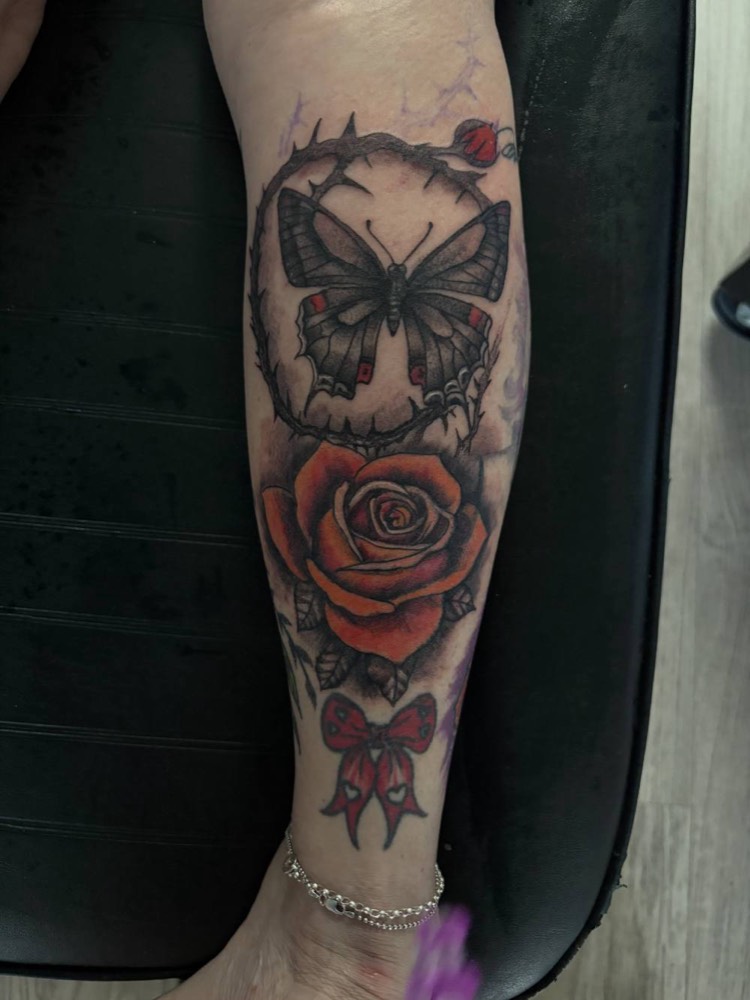 Butterfly and red rose on a calf